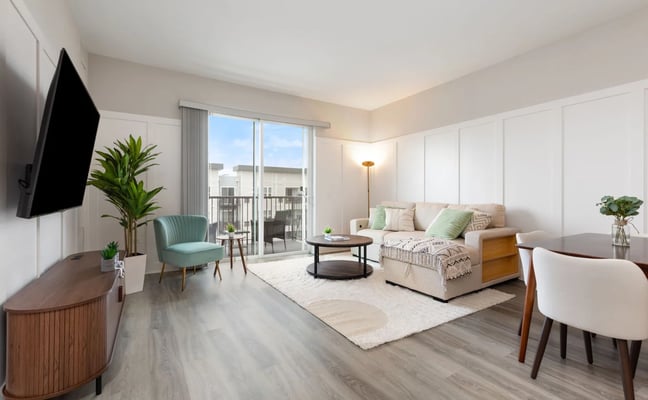 Bright furnished living room with balcony view at a House of Living property in Warrenville, IL